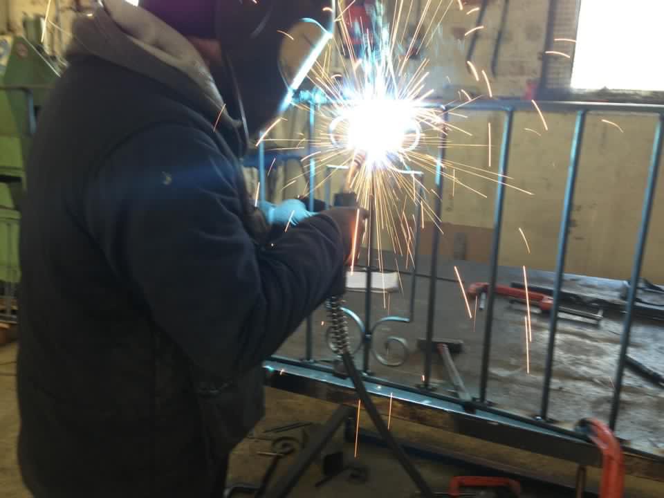 Martin Millar welding metal railings